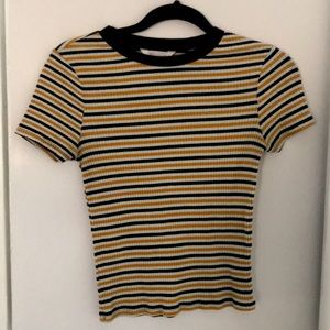 white, yellow, and dark blue striped shirt.